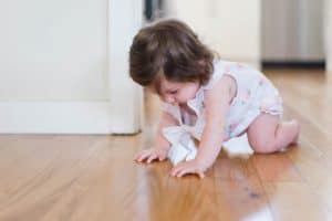 Child crawling on floor in clean home