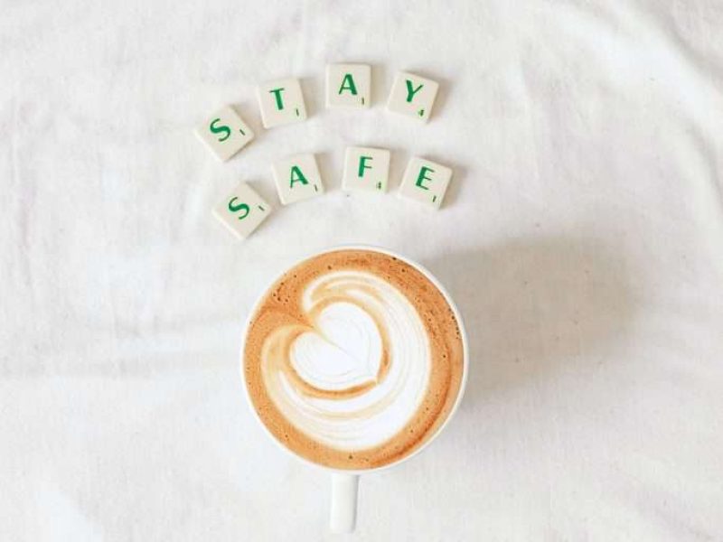 flatlay coffee cup and scrabble letters spelling stay safe